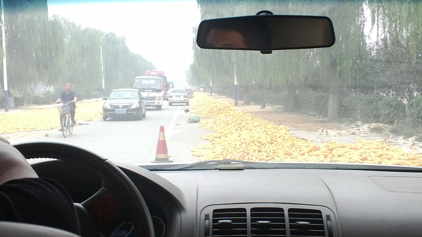 More mounds of corn on the streets, these blocking cars